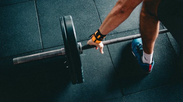 man holding weight lifting bar